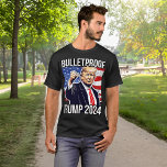 Bulletproof Pro Donald Trump 2024 Election USA T-Shirt<br><div class="desc">Donald Trump is still standing after an assassination attempt by a shooter at a Trump rally in Butler PA on July 13. Celebrate with this iconic Donald Trump 2024 fist pump graphic, patriotic red white and blue American flag with Bulletproof Quote T-Shirt, Unisex for Men or Women. 45th President Donald...</div>