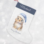 Bunny in Blue Santa's Hat Personalised<br><div class="desc">Personalised Christmas Santa Bunny Stocking, perfect for your little ones this holiday season. This adorable stocking features a cute little bunny wearing a blue Santa's hat covered with snow. Stocking can be personalised with your child's name. Hang it on your mantel or in your child's bedroom to add a festive...</div>