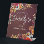 Burgundy Fall Flowers 70th Birthday Party Welcome Pedestal Sign<br><div class="desc">Beautiful fall flowers decorate two corners of this birthday party welcome sign. Red roses,  terracotta flowers and white peonies blend with deep green leaves and foliage. The flowers and white modern script pop against the burgundy red background. This item is part of the Burgundy Fall Flowers collection.</div>