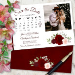 Burgundy Red & Pink Roses Wedding Calendar & Photo Save The Date<br><div class="desc">This beautiful wedding Save the Date card features a rustic boho chic design with script lettering and a cluster of hand painted watercolor roses in shades of burgundy, red, and blush pink. There is a customisable calendar where you can put a heart around your wedding date with space for your...</div>