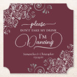 Burgundy & Silver Posh Don't Take My Drink Wedding Paper Coaster<br><div class="desc">This wedding coaster is elegant, stylish, and fun! It features a beautiful silver-grey and burgundy coloured design with modern script lettering and delicate faux foil curls and swirls in the corners. The text reads "Please don't take my drink, I'm dancing" with space for the names of the couple and wedding...</div>