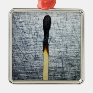 Burned match on stainless steel metal tree decoration
