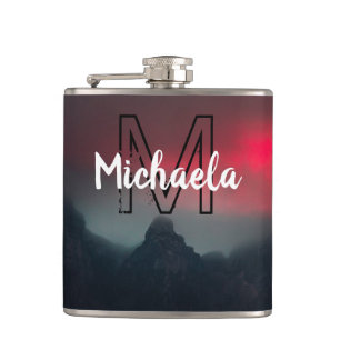 Burning clouds, fog and mountains monogram in sky hip flask