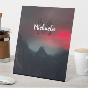 Burning clouds, fog and mountains monogram in sky pedestal sign