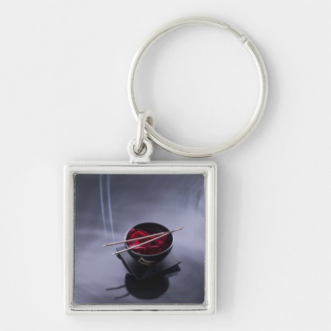 Burning incense on top of bowl of petals key ring (Front)
