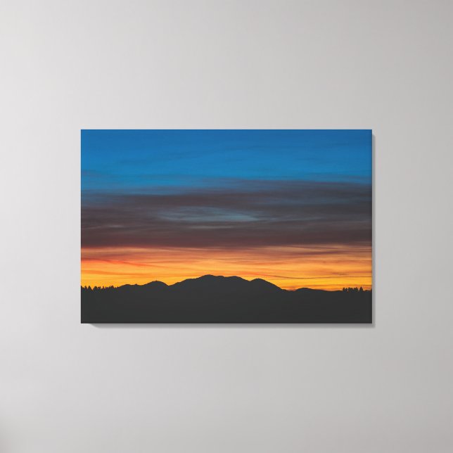 Burning sunset above landscape silhouette canvas print (Front)