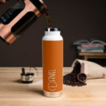 Burnt Orange Modern Typography Personalised Water Bottle<br><div class="desc">Trendy, vacuum insulated water bottle that features personalised name in white, modern typography on a trendy, burnt orange colour background. Personalise bottle by editing name and replacing name with your own as desired. Perfect for a birthday gift, wedding groomsman gift, etc. Select your water bottle style. Select your water bottle...</div>
