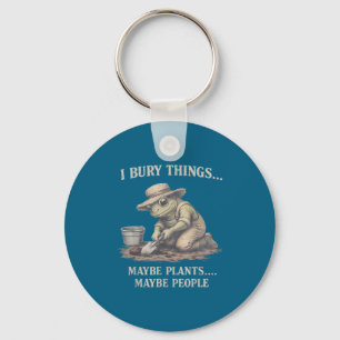 Bury things maybe plants maybe people frog key ring