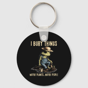 Bury things maybe plants maybe people funny frog key ring