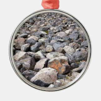 Bush setting of man made rock formation pattern metal tree decoration