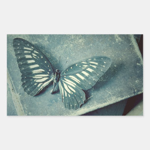Butterfly on vintage books rectangular sticker