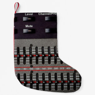 Buttons on a sound mixer in a recording studio. small christmas stocking