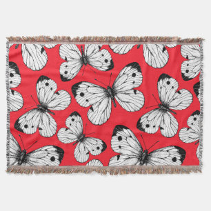 Cabbage butterfly pattern on red throw blanket