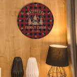 Cabin Family Name Red Buffalo Plaid Large Clock<br><div class="desc">Create a personalised, commemorative round wall clock featuring a rustic red and black buffalo check plaid design and an image of forest pine trees in the woods with your custom text in brown (shown with NAME FAMILY CABIN and year established date). All text is editable. Ideal for a family cabin,...</div>