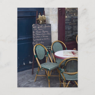 Cafe table with cane chairs in Paris, France Postcard
