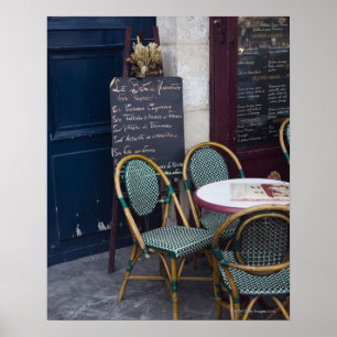 Cafe table with cane chairs in Paris, France Poster
