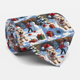 Cairn Terrier Running in Snow with Christmas Hat Tie