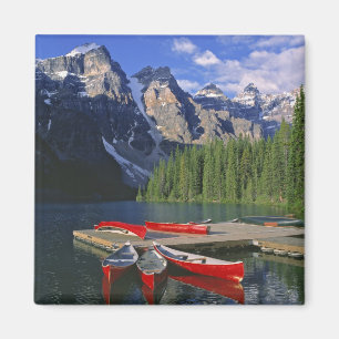 Canada, Alberta, Moraine Lake. Red canoes await Magnet