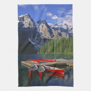Canada, Alberta, Moraine Lake. Red canoes await Tea Towel