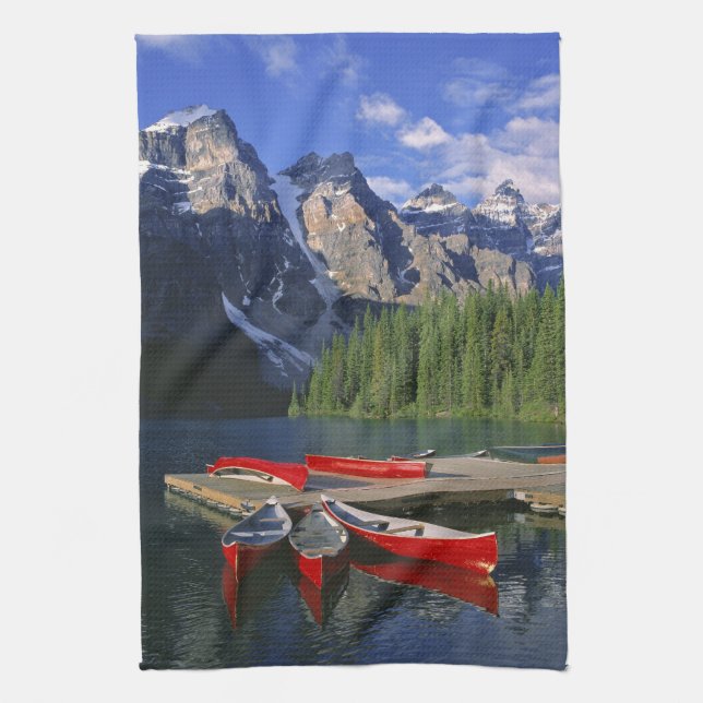 Canada, Alberta, Moraine Lake. Red canoes await Tea Towel (Vertical)