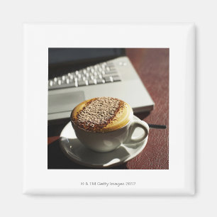 Cappuccino in front of laptop magnet
