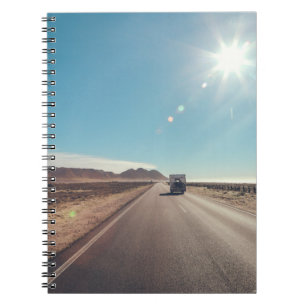 Car on black asphalt road notebook