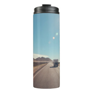 Car on black asphalt road thermal tumbler