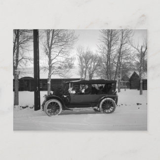 Car with Christmas tree tied on the hood Holiday Postcard