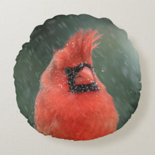 Cardinal in a pine tree during a snow storm round cushion
