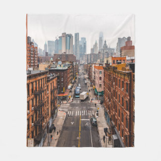 CARS ON ROAD BETWEEN HIGH RISE BUILDINGS DURING DA FLEECE BLANKET