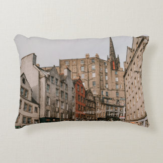 CARS PARKED BESIDE BROWN CONCRETE BUILDING DURING DECORATIVE CUSHION
