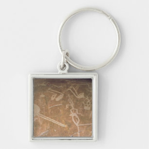 Carved petroglyph depicting figures key ring