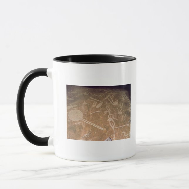 Carved petroglyph depicting figures mug (Left)