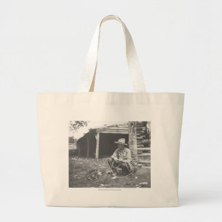 Cat eating out of a coffee can. large tote bag