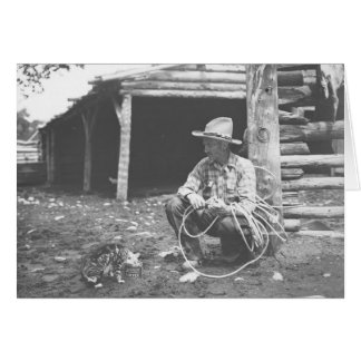 Cat eating out of a coffee can with a cowboy watch
