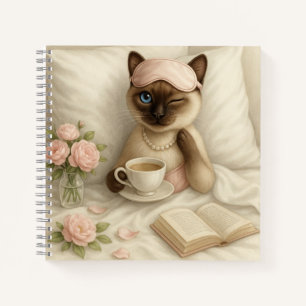 Cat is drinking coffee in bed notebook