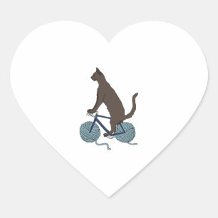 cat riding bike with yarn ball wheels heart sticker