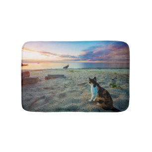 Cat Sitting On A Beach Bath Mat