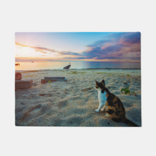 Cat Sitting On A Beach Doormat