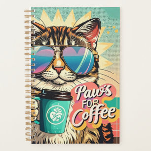 Cat wearing oversized sunglasses with coffee planner