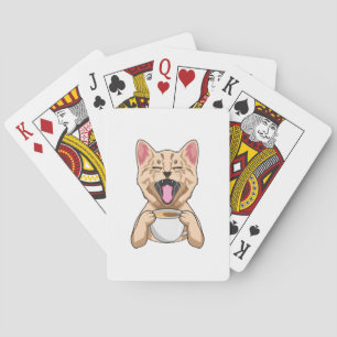 Cat with cup of coffee playing cards