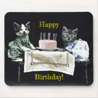 Cats celebrating a birthday with cake and candles