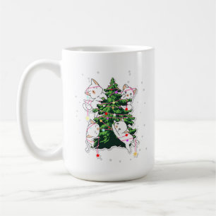 cats climbing and decorating a Christmas tree  Coffee Mug