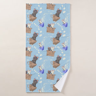 Cats in box and milk drops on blue bath towel