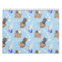 Cats in box and milk drops on blue