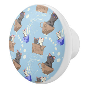 Cats in box and milk drops on blue ceramic knob