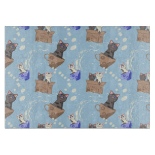 Cats in box and milk drops on blue cutting board