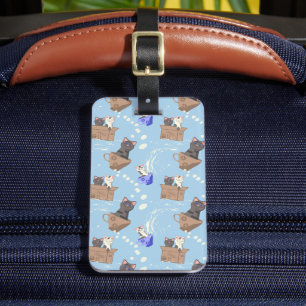 Cats in box and milk drops on blue luggage tag