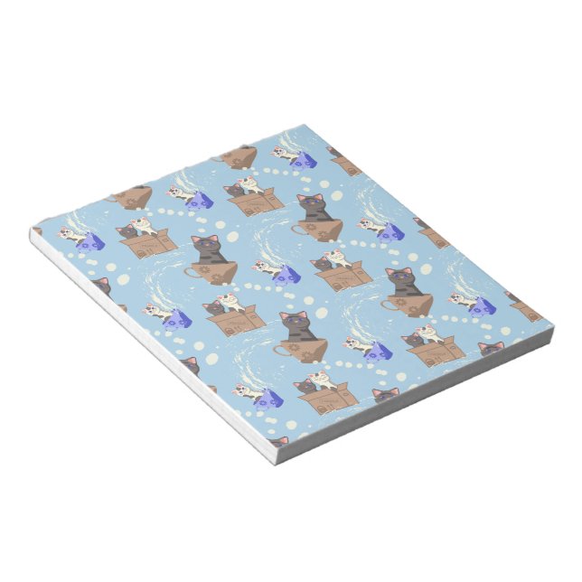 Cats in box and milk drops on blue notepad (Angled)