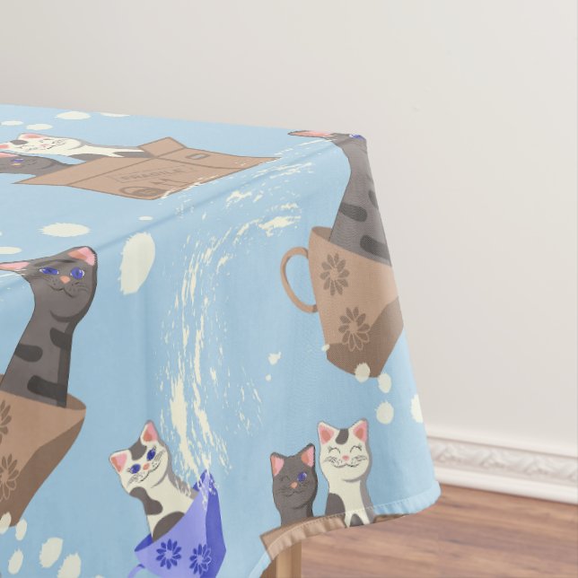 Cats in box and milk drops on blue tablecloth (In Situ)
